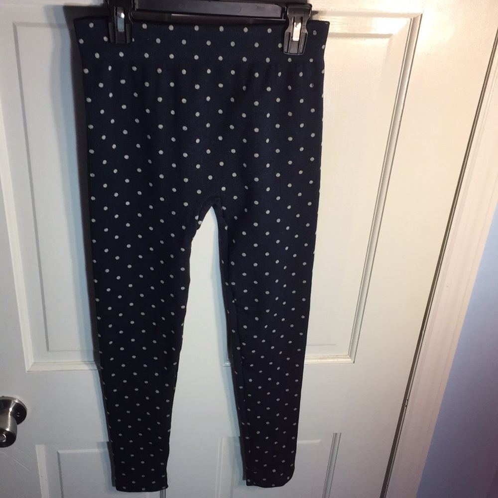 Dark blue jeggings with white polka dots.
